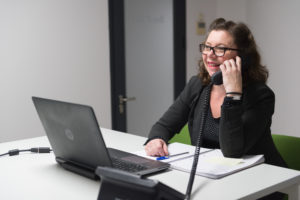 femme souriante au téléphone dans bureau